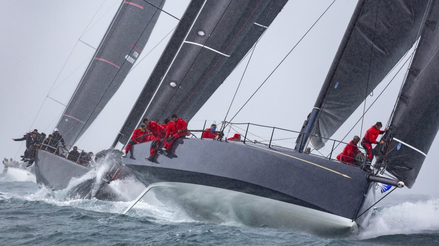 A squall lashes the front runners as they round the top mark in today's first race. Photos: IMA / Studio Borlenghi