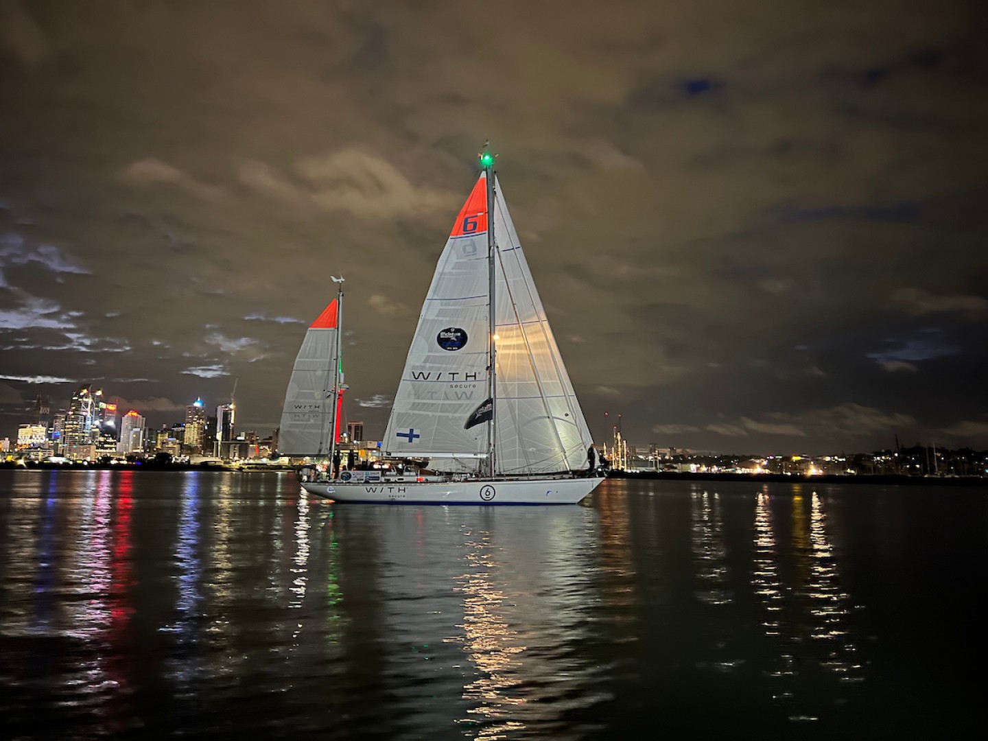 The stunning Finnish Swan 55, the oldest yacht in the race at 53 years old, sailing majestically TOWARD THE FINISH LINE IN Auckland waters AS DAYLIGHT STARTS TO APPEAR. Credit: OGR2023 / Don McIntyre