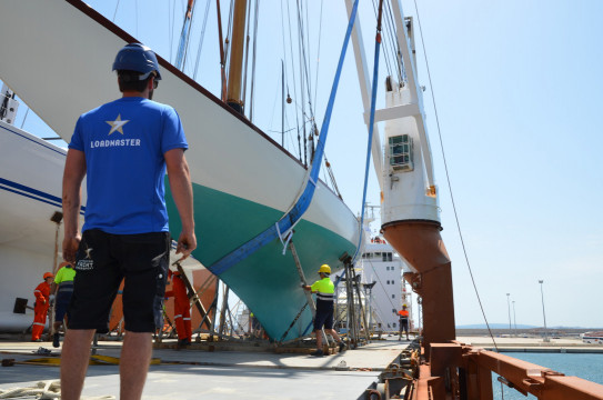 A classic yacht is carefully loaded and secured for an ocean passage aboard Sevenstar’s specialist transport ship Spuigracht in Palma de Mallorca