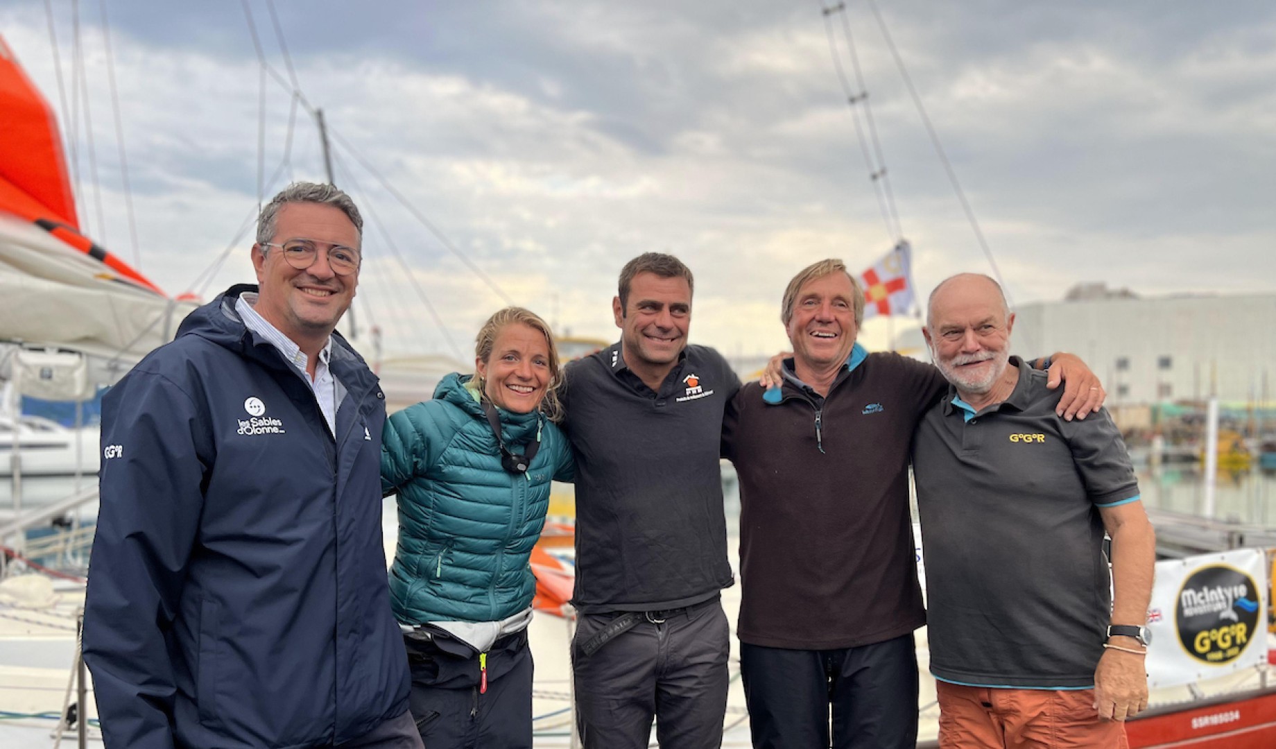 Moreau, mayor of Le Sables D'Olonne (L) and Don McIntyre (R), welcome Curwen, Guillou and Curwen in the early hours of the morning