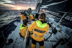 Leg 8 from Itajai to Newport, day 3 on board Turn the Tide on Plastic. 24 April, 2018. Liz Wardley on the helm during sunrise