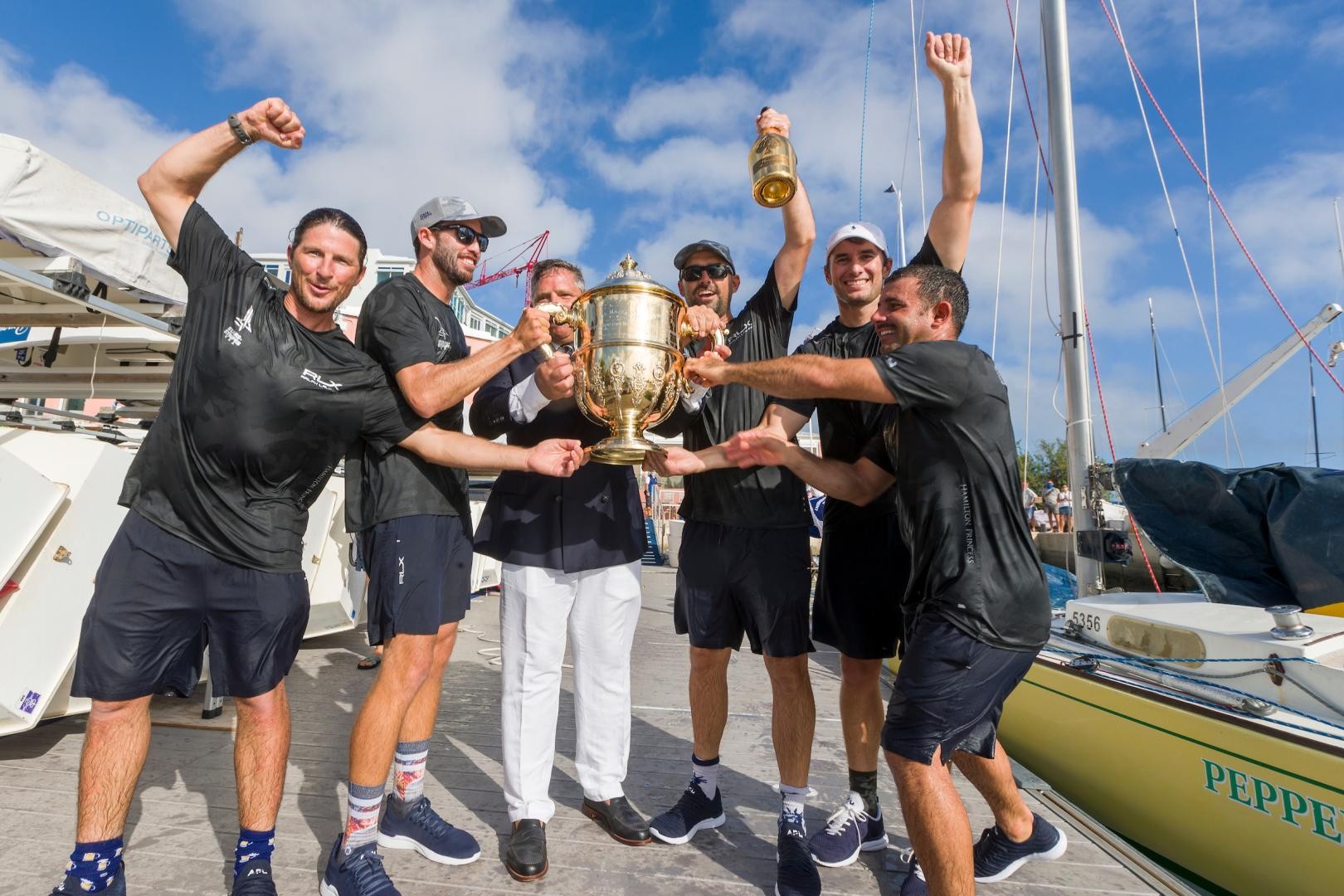 RBYC Commodore David Benevides presents Team Stars+Stripes with the King Edward VII Bermuda Gold Cup (from left) Eric Shampain, skipper Taylor Canfiel