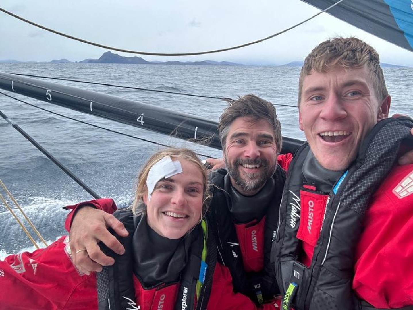 27March 2023: onboard Team Malizia. Will Harris takes a selfie with skipper Boris Herrmann and Rosalin Kuiper, recovering from her head injury, as the team lead the Ocean Race round Cape Horn