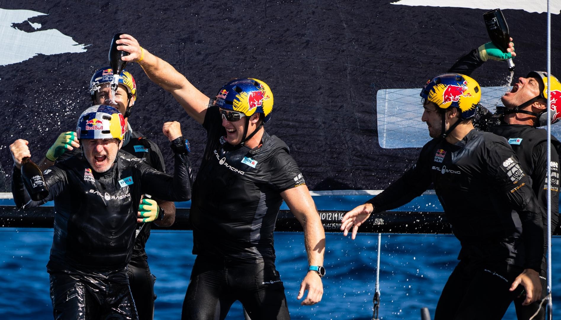Celebrations on board Red Bull Sailing Team, as Hagara and Steinacher claim their first World Champion in 22 years. Photo: GC32 Racing Tour / Sailing Energy