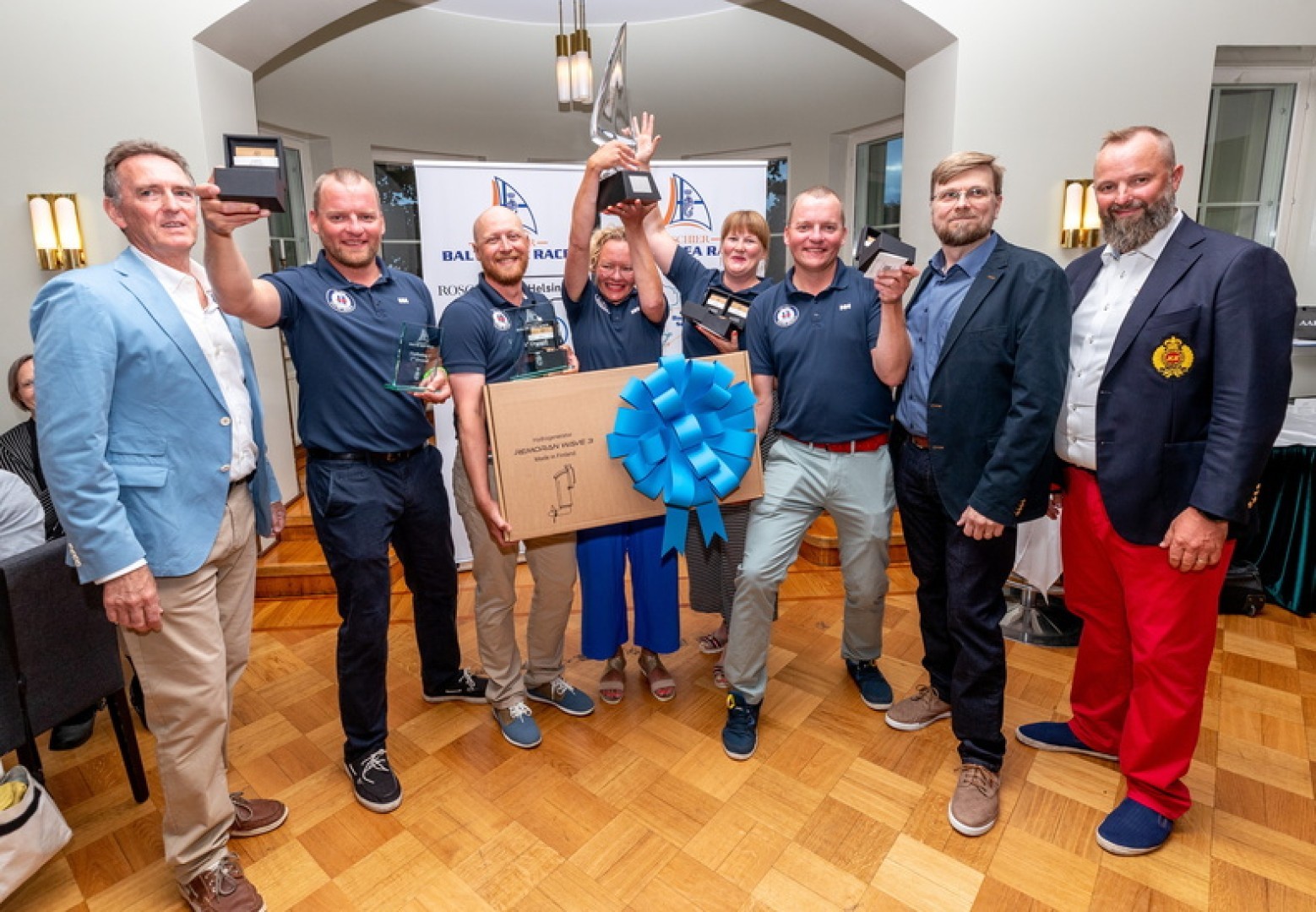 The jubliant crew of the Finnish H-323 Silver Moon II - first recipients of the Baltic Sea Race Trophy and a spoil of prizes