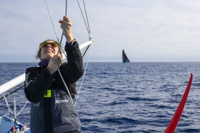 The Ocean Race 2022-23 - 18 March 2023, Leg 3, Day 21 onboard Biotherm. Sam Davies hoists the sail with Team Malizia in the background.
© Ronan Gladu / Biotherm / The Ocean Race