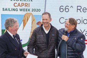 Alex Schaerer and Francesco de Angelis are presented with a 2019 Rolex Capri Sailing Week trophy by IMA Secretary General Andrew McIrvine. Photo: Studio Borlenghi / International Maxi Association.