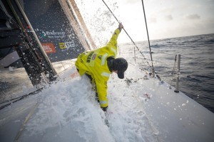 Leg 8 from Itajai to Newport, day 11 on board Brunel. Abby Ehler on the bow cleaning Sargassum weeds.