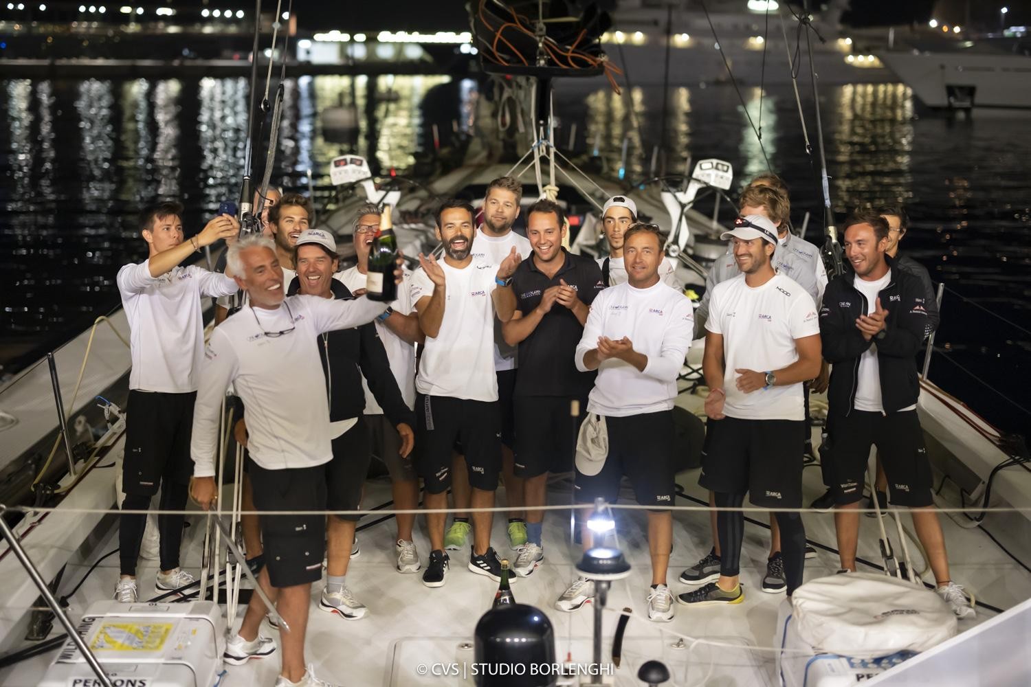 Guido Miani, Furio Benussi and the Arca SGR crew celebrate their line honours victory.