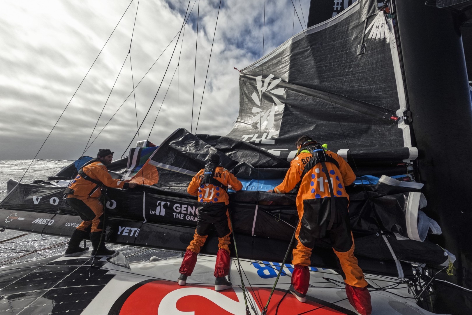 Leg 3 on board 11th Hour Racing Team. Charlie Enright, Justine Mettraux and Jack Bouttell work on replacing the broken batten and patching up the mainsail.
© Amory Ross